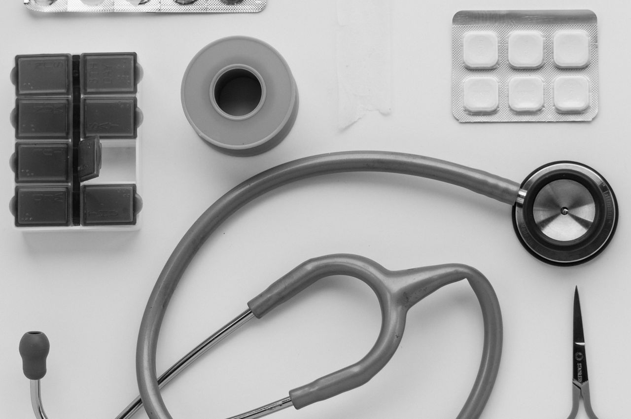 Mastering the First Impression: Your intriguing post title goes here Top view of medical instruments and pills arranged on a white background.